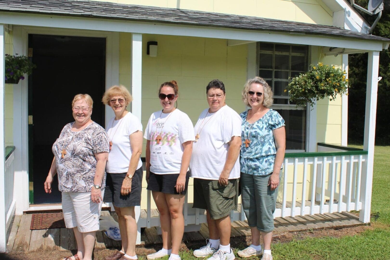 A group of people standing in front of a house.