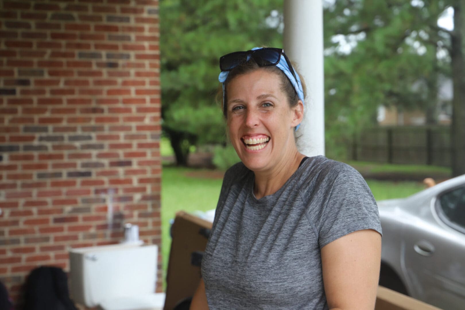 A woman sitting on top of a wooden bench.