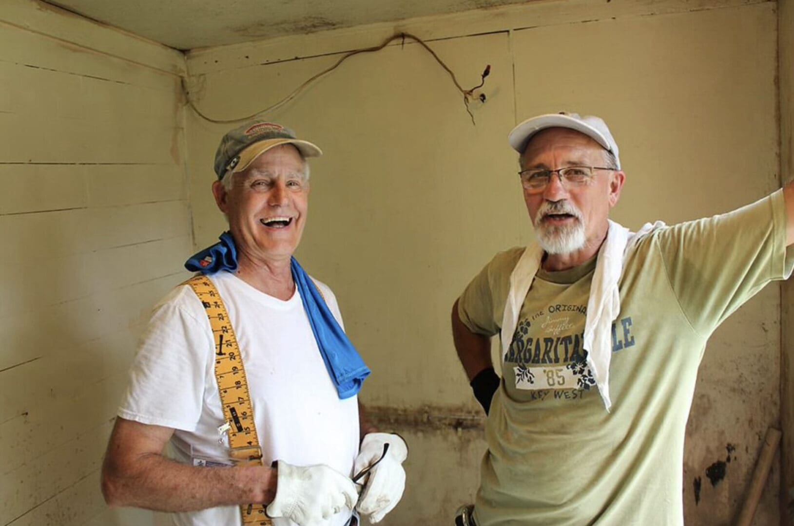 Two men standing next to each other in a room.